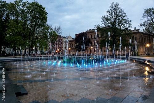 Lublin, Poland - May 14, 2019: Large pedestrian area with beautiful fountains in the evening.