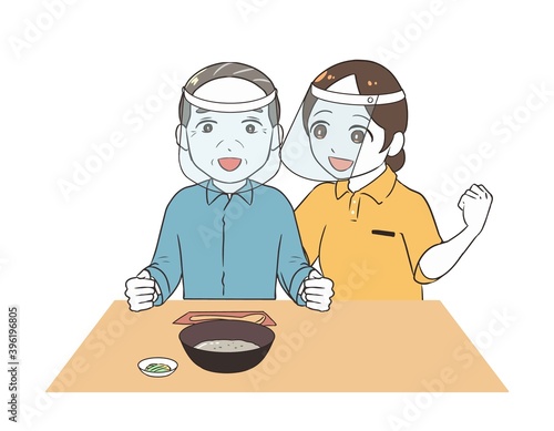 お粥を食べる高齢男性　女性介護士　フェイスシールド