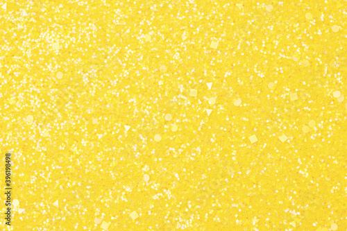 Holographic bright yellow glitter real texture background.