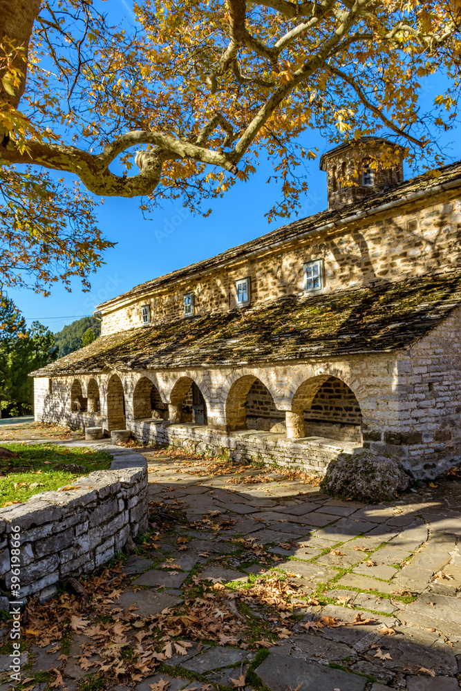 Taxiarchon stone built  church  during  fall season in the picturesque village of Mikro  papigo in Epirus zagori greece