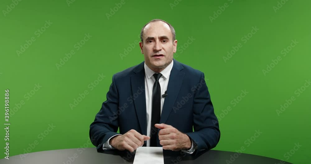 Male newsanchor informing about current news. Professional television live reporter talking about recent global events in business and politics. Chroma key green background 4k footage Male newsanchor informing about current news. Professional television live reporter talking about recent global events in business and politics. Chroma key green background 4k footage