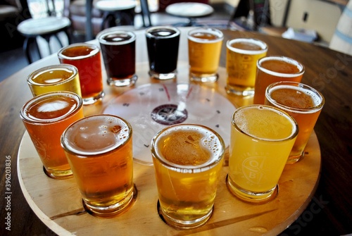 A flight of beer samplers. Beers range from light pale ales through dark stouts. Pilsner, lager, bock, Kölsch, bitter, Irish Red Ale, American Brown Ale, Amber, Brown Ale, Porter, India Pale Ale (IPA) photo