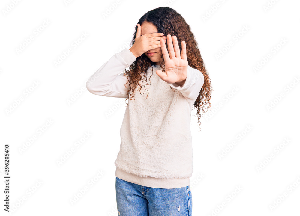 Beautiful kid girl with curly hair wearing casual clothes covering eyes with hands and doing stop gesture with sad and fear expression. embarrassed and negative concept. Beautiful kid girl with curly hair wearing casual clothes covering eyes with hands and doing stop gesture with sad and fear expression. embarrassed and negative concept.