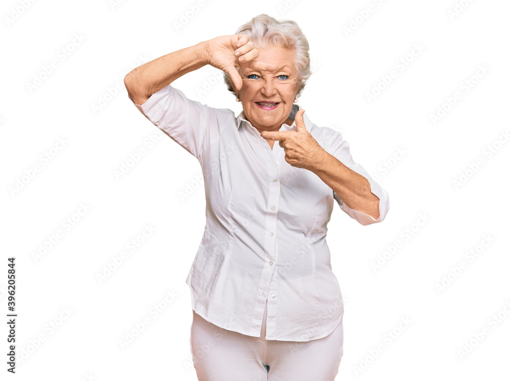 Senior grey-haired woman wearing casual clothes smiling making frame with hands and fingers with happy face. creativity and photography concept. Senior grey-haired woman wearing casual clothes smiling making frame with hands and fingers with happy face. creativity and photography concept.