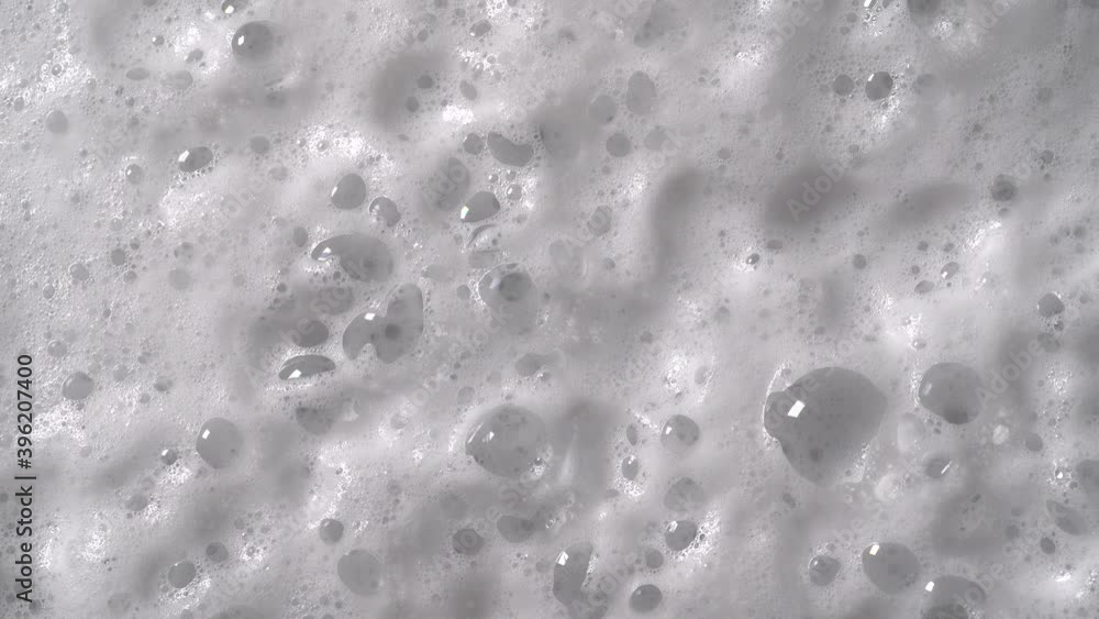 White foam with bubbles texture, soap, detergent or shampoo or cleanser surface, macro shot. White foam with bubbles texture, soap, detergent or shampoo or cleanser surface, macro shot.