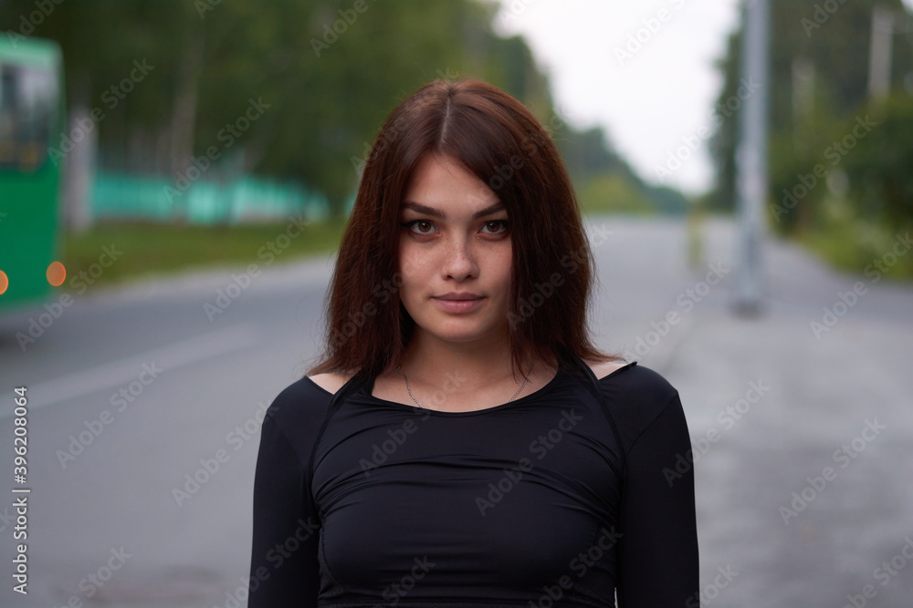 beautiful girl with freckles in a black tracksuit on the road.sports lifestyle. beautiful girl with freckles in a black tracksuit on the road.sports lifestyle.