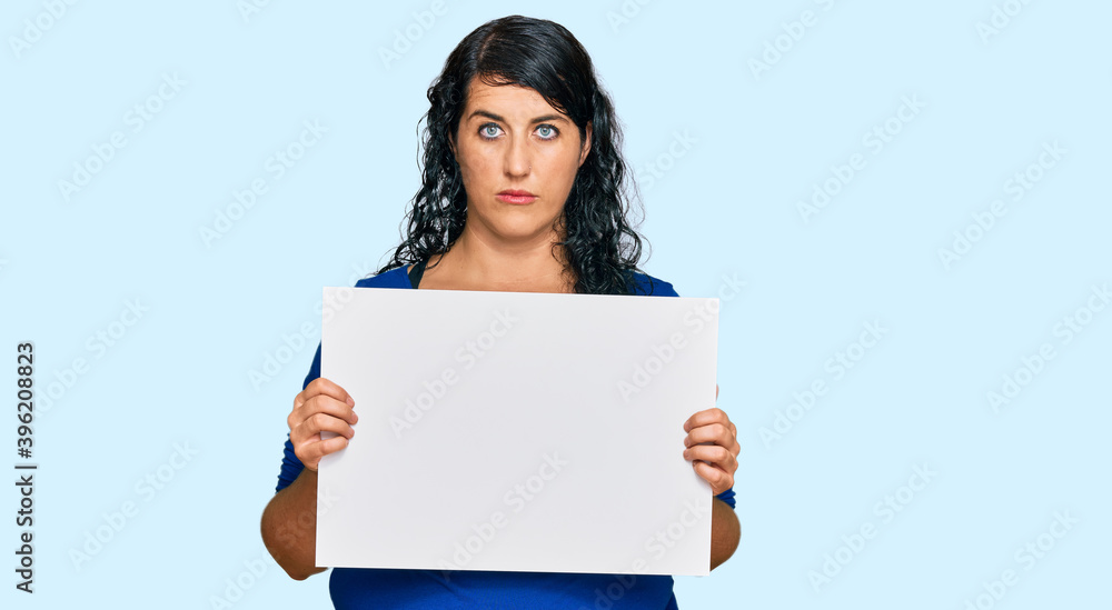 Plus size brunette woman holding blank empty banner surprised with an idea or question pointing finger with happy face, number one Plus size brunette woman holding blank empty banner surprised with an idea or question pointing finger with happy face, number one