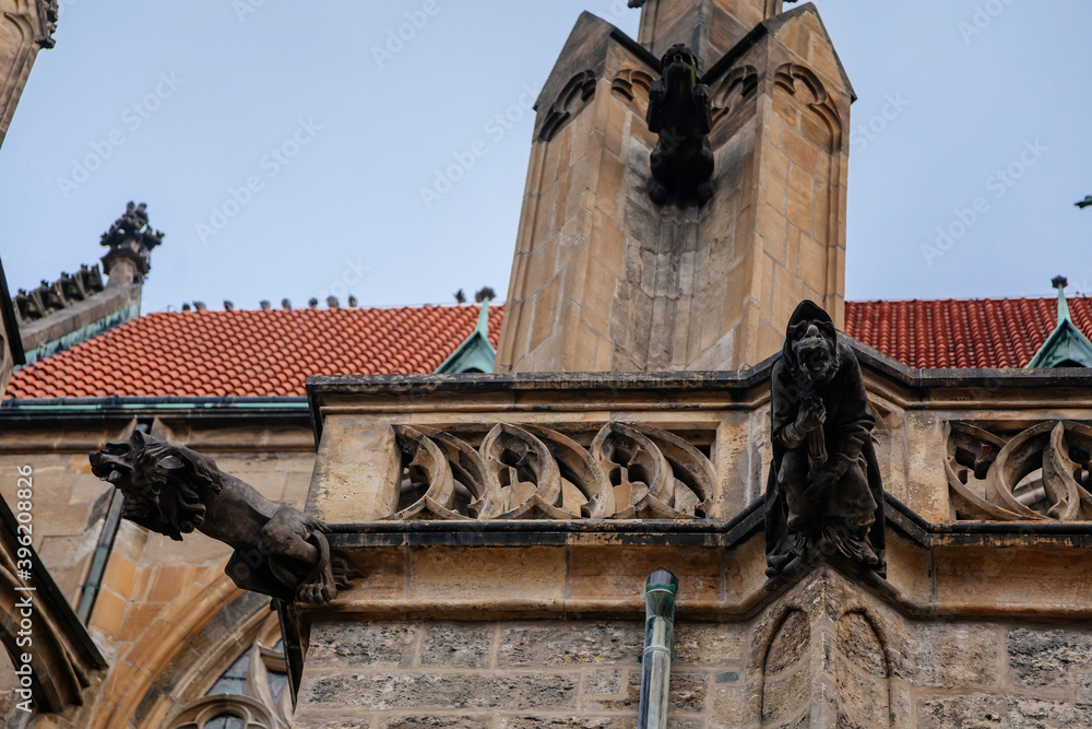 Low angle view at a part of Medieval stone St. Bartholomew´s Church in autumn day, arched windows, chimeras and gargoyles, Gothic Cathedral, Kolin, Central Bohemia, Czech republic