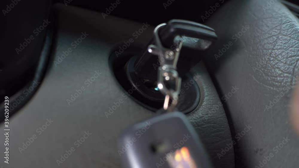 The driver inserts the ignition key into the ignition lock, turns it