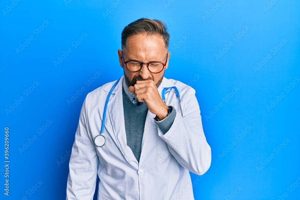 Handsome middle age man wearing doctor uniform and stethoscope feeling unwell and coughing as symptom for cold or bronchitis. health care concept. Handsome middle age man wearing doctor uniform and stethoscope feeling unwell and coughing as symptom for cold or bronchitis. health care concept.