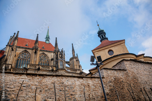 Medieval stone St. Bartholomew´s Church in Kolin, Gothic Cathedral and baroque building of Ossuary in autumn day, arched windows, chimeras, Central Bohemia, Czech republic photo