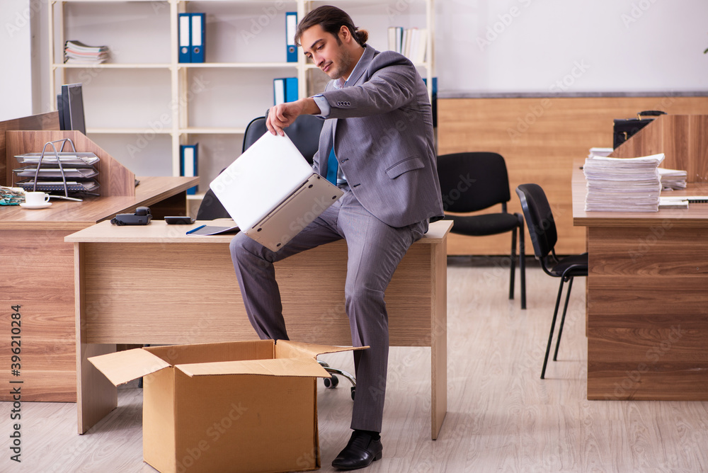Young male employee being dismissed from his work Young male employee being dismissed from his work