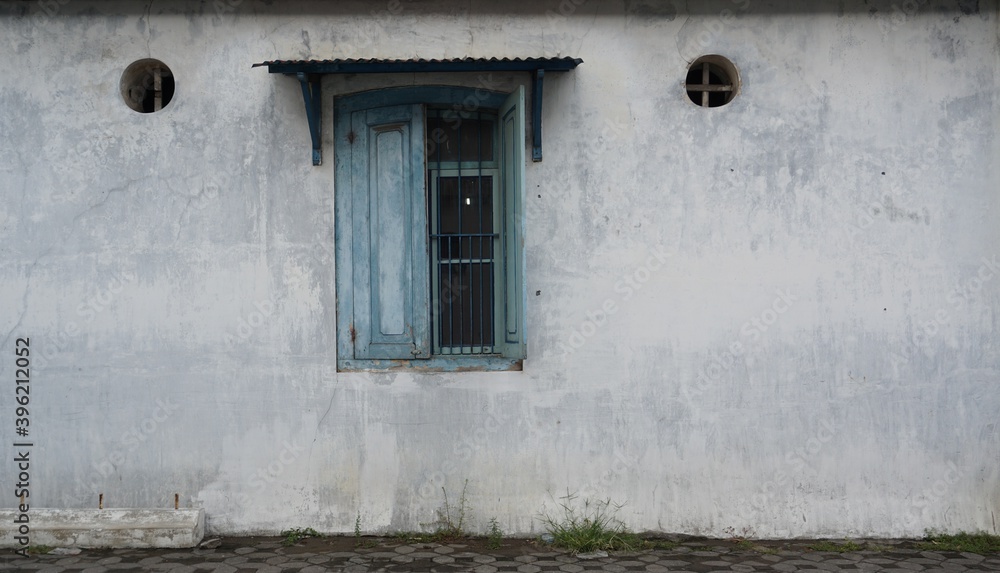The old wall between the blue windows belongs to the Kasunanan Keraton Surakarta, Central Java, Indonesia. The old wall between the blue windows belongs to the Kasunanan Keraton Surakarta, Central Java, Indonesia.