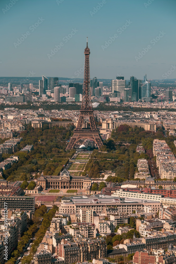 Aerial view of Paris with the Eiffel tower in the center of the image.