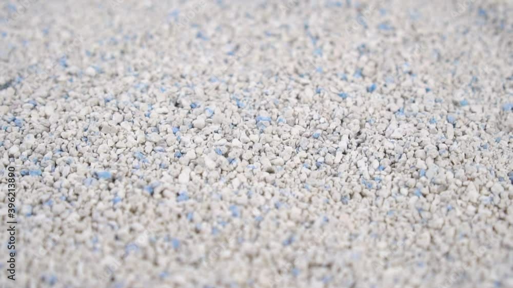 Absorbent Cat Litter Granules are piled up with rotation. Slow motion. Selective focus Absorbent Cat Litter Granules are piled up with rotation. Slow motion. Selective focus