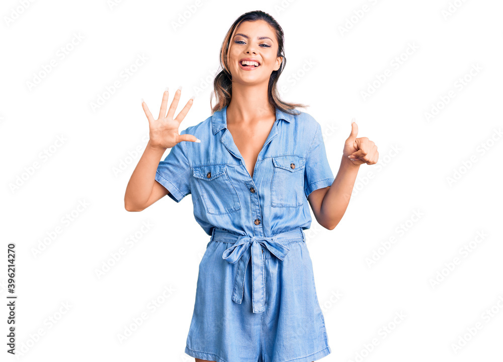 Young beautiful woman wearing casual clothes showing and pointing up with fingers number six while smiling confident and happy. Young beautiful woman wearing casual clothes showing and pointing up with fingers number six while smiling confident and happy.
