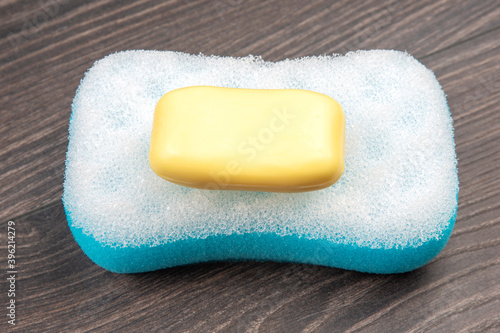 bath sponge and soap on wooden background