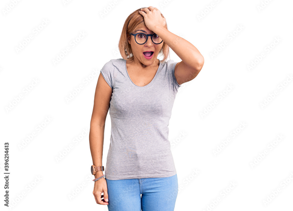 Young blonde woman wearing casual clothes surprised with hand on head for mistake, remember error. forgot, bad memory concept. Young blonde woman wearing casual clothes surprised with hand on head for mistake, remember error. forgot, bad memory concept.