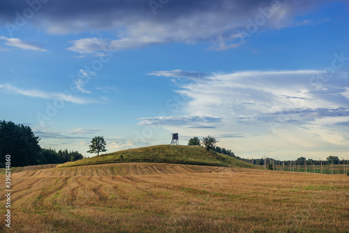 Fototapeta Naklejka Na Ścianę i Meble -  Rural landscape with wooden hunting tower in Masurian Lakeland region of Poland
