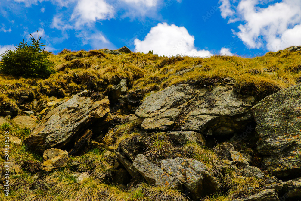 View of the cliffs or part of the mountains with blue sky, background.