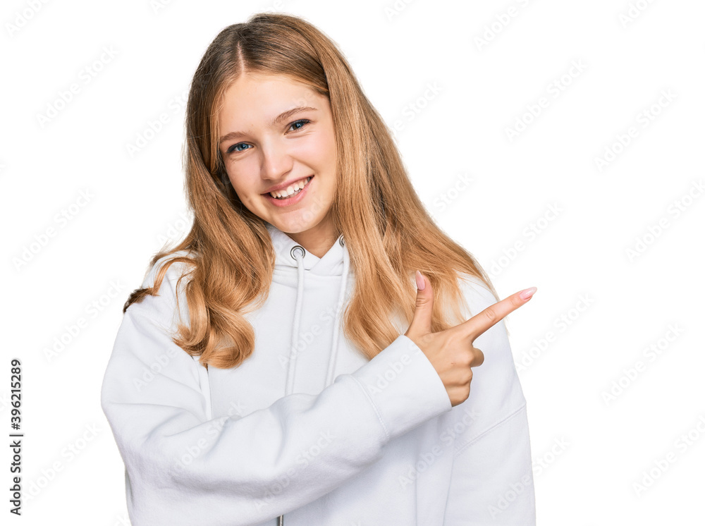 Beautiful young caucasian girl wearing casual sweatshirt cheerful with a smile of face pointing with hand and finger up to the side with happy and natural expression on face Beautiful young caucasian girl wearing casual sweatshirt cheerful with a smile of face pointing with hand and finger up to the side with happy and natural expression on face