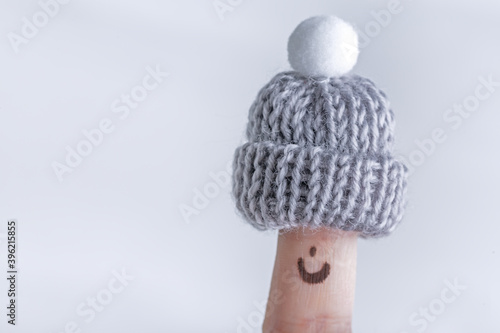 Fingers in knitted warm small hats  winter season concept