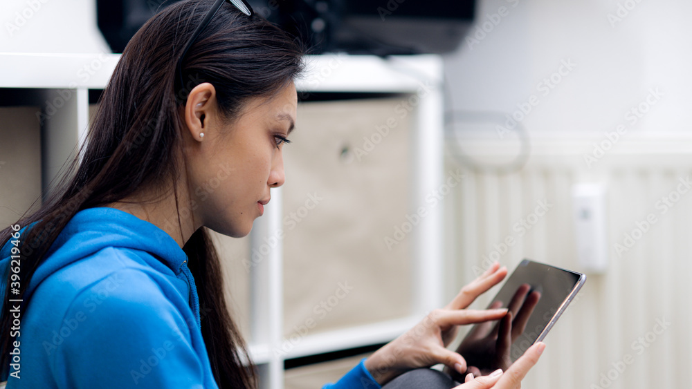 Young woman works with a tablet computer - home shooting Young woman works with a tablet computer - home shooting