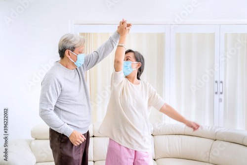 Happy senior couple dance during quarantine at home