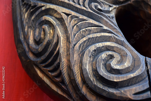 Close up detail of a carved wooden koru pattern