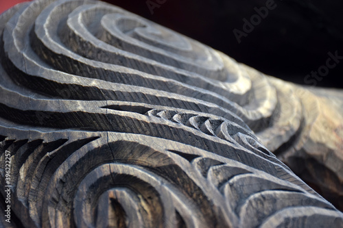 Konstfotografi Close up detail of a carved wooden koru pattern