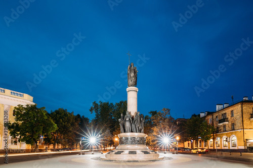 Brest, Belarus. View Of Millennium Monument Of Brest At Intersection Of Sovietskaya And Gogol Street In Evening Night Illuminations. Monument Presents Group Of Bronze Statues.