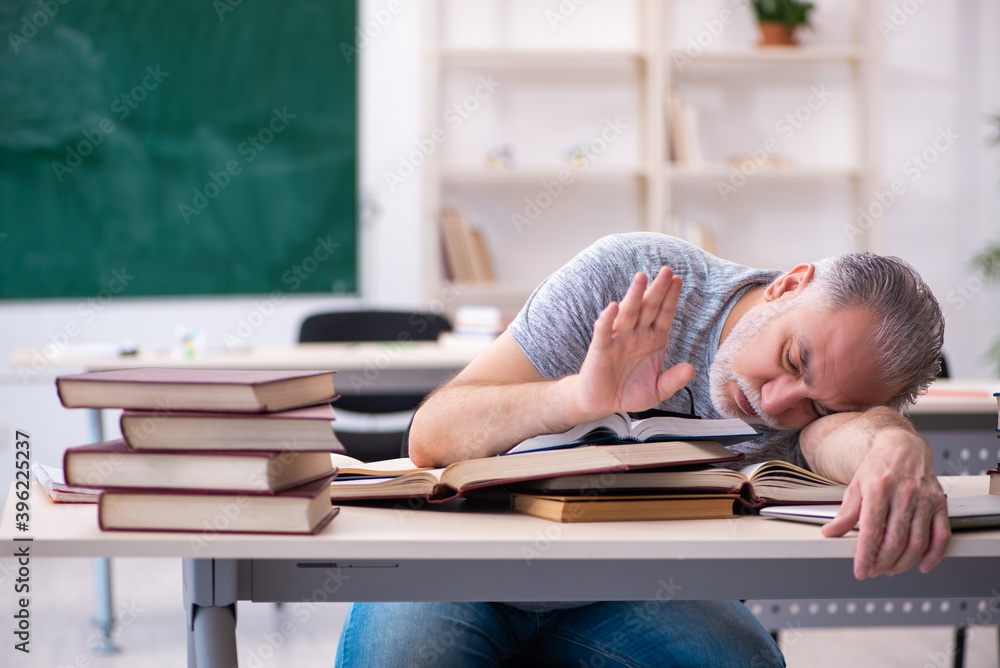 Old male student being exhausted during exam preparation Old male student being exhausted during exam preparation
