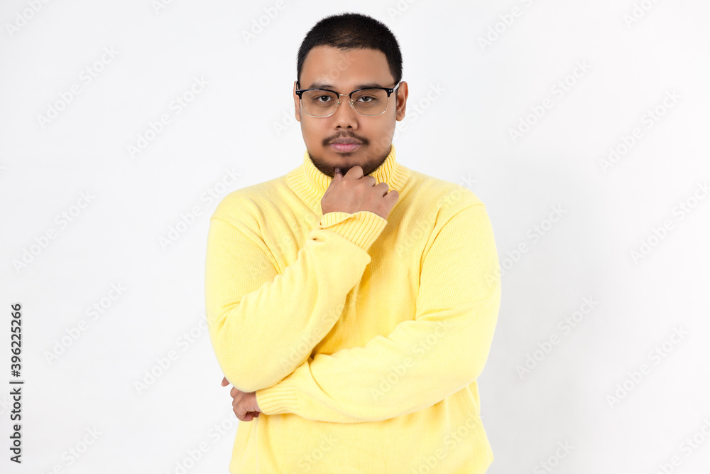 Fototapeta premium Asian man with a contemplative expression on a white background