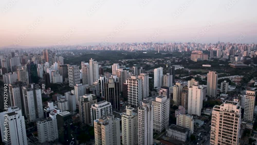 Aerial view of skyscraper buildings, during a colorful sunset, in the Indianopolis area of Sao Paulo city, Brazil, South America - tracking, drone shot Aerial view of skyscraper buildings, during a colorful sunset, in the Indianopolis area of Sao Paulo city, Brazil, South America - tracking, drone shot