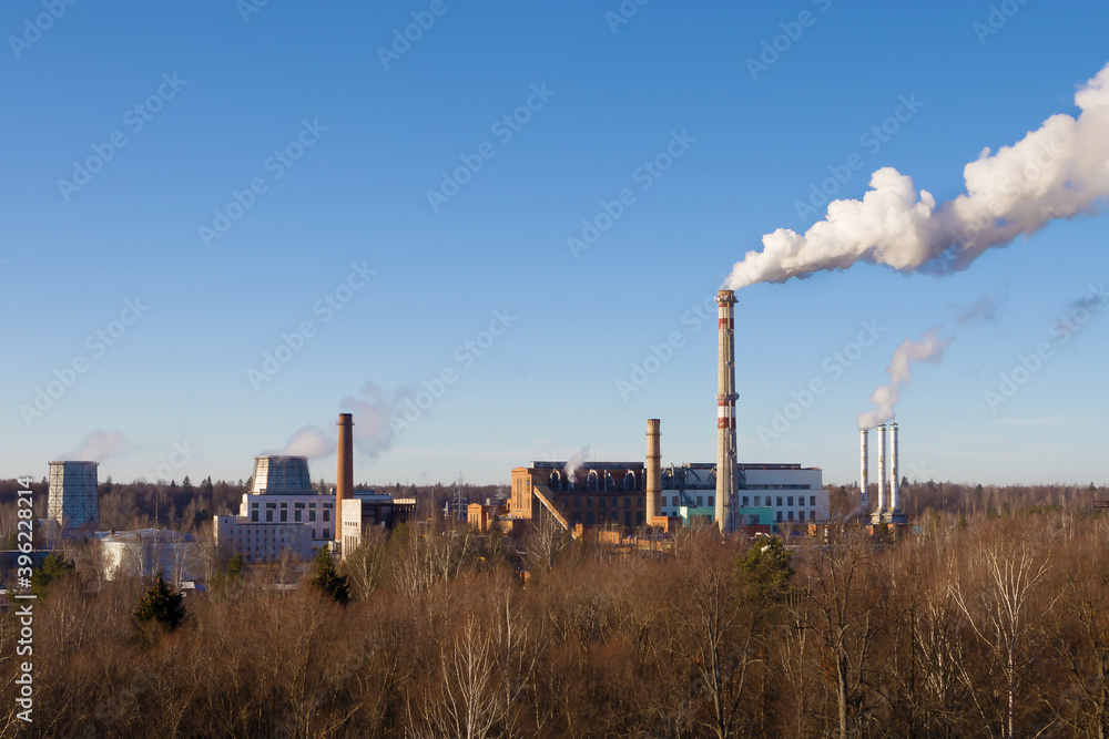 Thermal power plant. The smoke comes from a tall chimney.