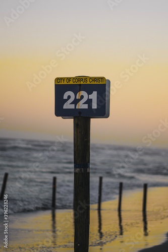 Sunset by the beach with post sign