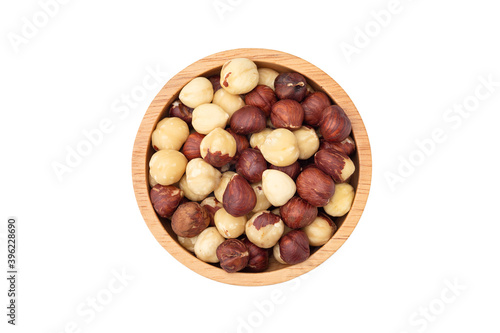 Hazelnut in wooden bowl isolated on white