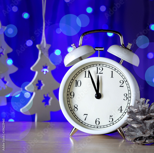 Happy New Year greeting card with vintage clock and holiday decoration on blue background.