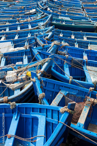 Blue fishing boats aligned in Essaouira