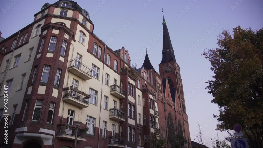 Dolly slider of old apartment and historic church in Friedrichshain district during beautiful evening with clear sky in Berlin. Dolly slider of old apartment and historic church in Friedrichshain district during beautiful evening with clear sky in Berlin.
