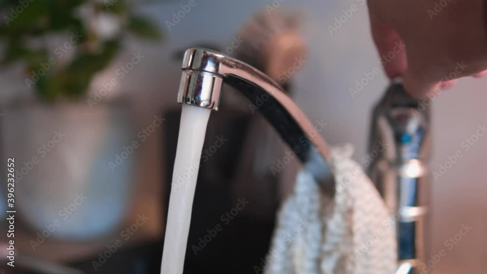 Slow-motion of the faucet being turned on and water flowing. Slow-motion of the faucet being turned on and water flowing.
