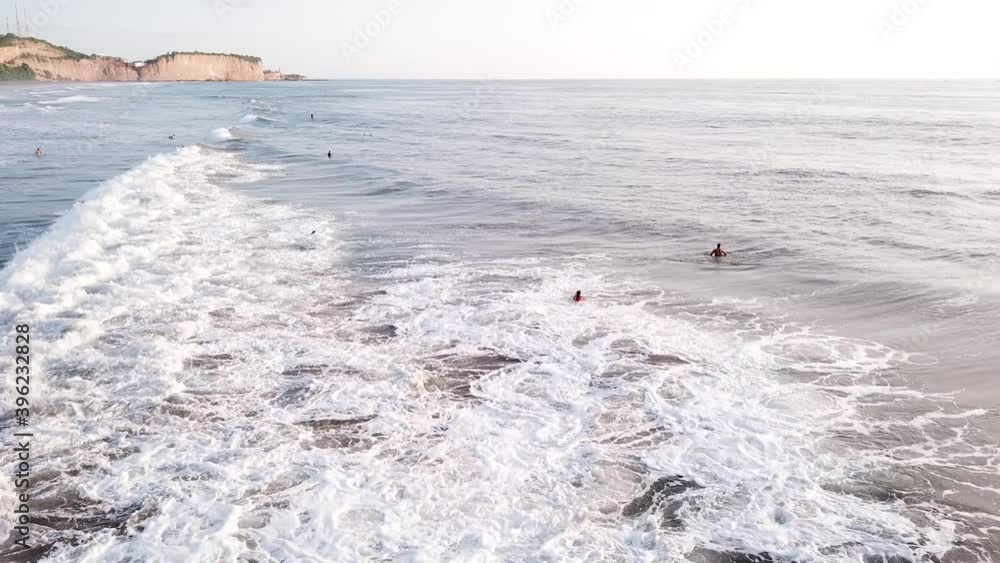 Powerful Sea Water Surge With Surfers On Its' Surface During Summer In Olon Beach, Ecuador. - Aerial Wide Shot Powerful Sea Water Surge With Surfers On Its' Surface During Summer In Olon Beach, Ecuador. - Aerial Wide Shot