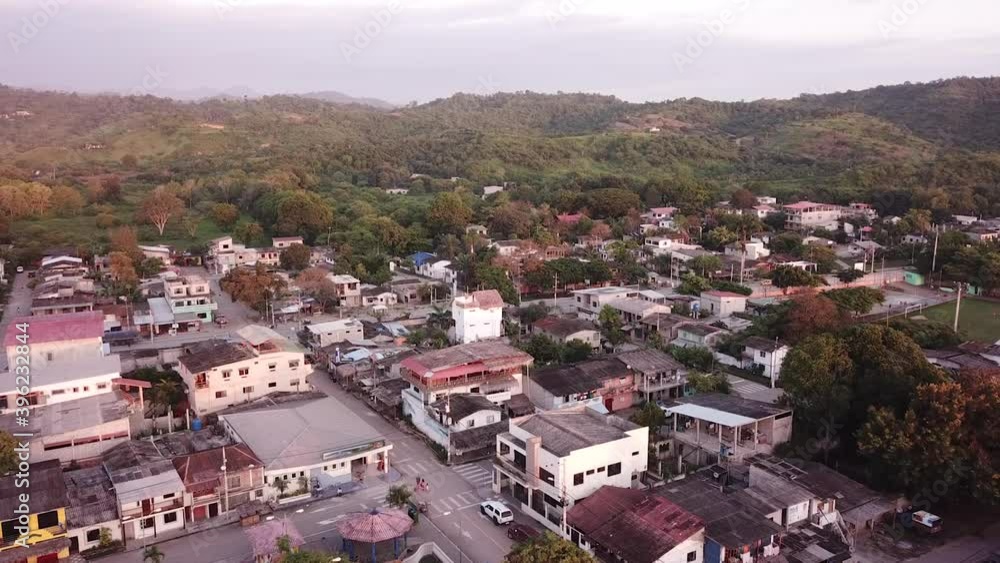 Scenery Of City Landscape With Forest Mountain In Background By The Island Of Olon In Ecuador. - Aerial Panning Shot Scenery Of City Landscape With Forest Mountain In Background By The Island Of Olon In Ecuador. - Aerial Panning Shot