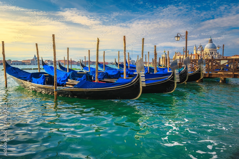 Moored gondolas at sunrise by Saint Mark square, Venice, Italy Moored gondolas at sunrise by Saint Mark square, Venice, Italy