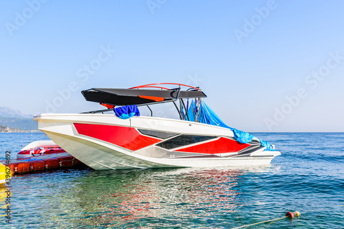 Modern motor boat moored in sea near the shore