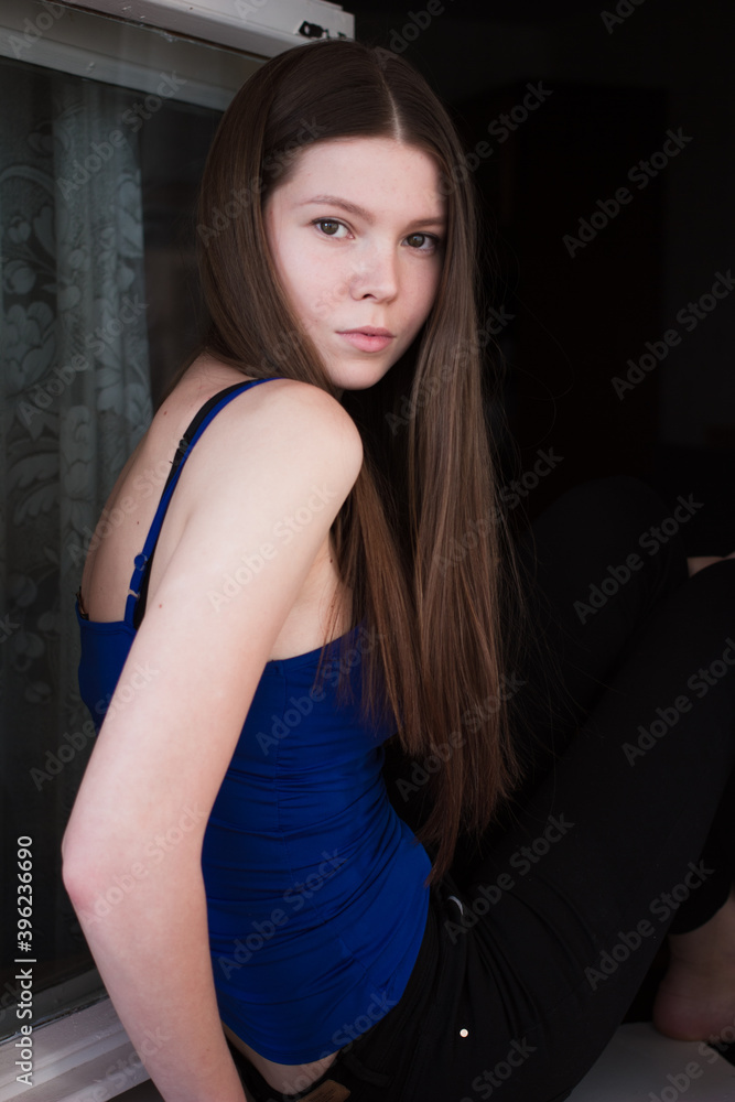 portrait of a woman with brown hair in blue shirt portrait of a woman with brown hair in blue shirt