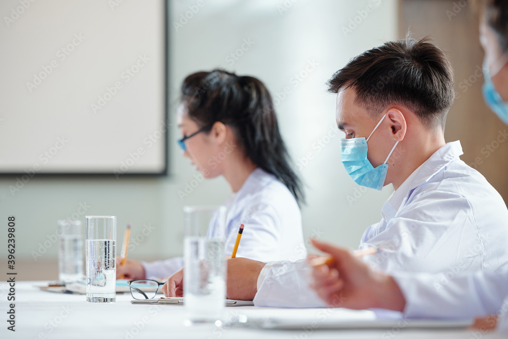 Young doctors and researchers attending lecture on new ways of coronavirus spread and treatment Young doctors and researchers attending lecture on new ways of coronavirus spread and treatment