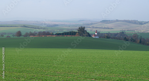 Green landscape, autumn Moravian landscape, fields, view of the village and the church.