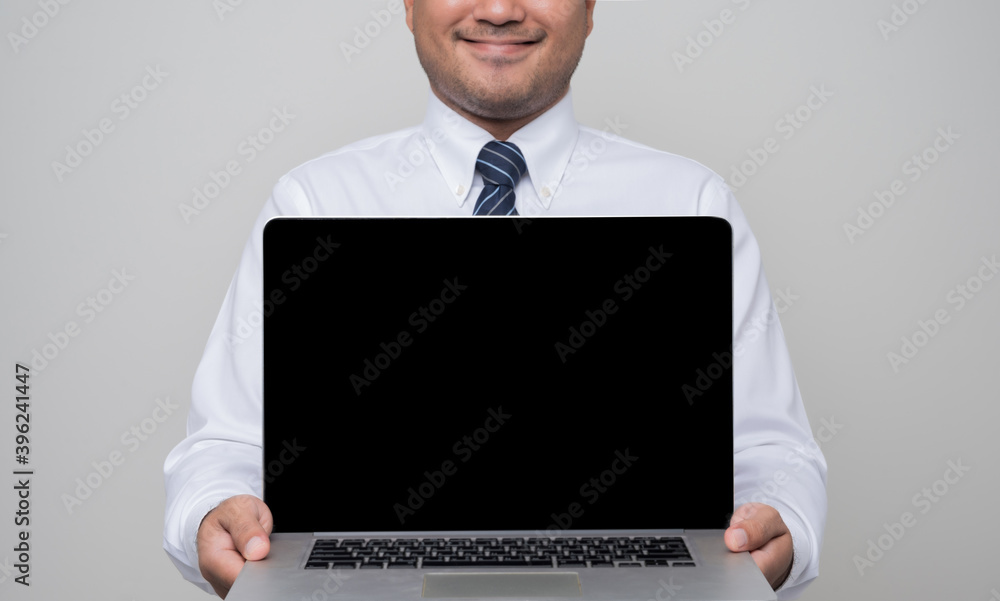 Businessman holding blank screen laptop showing in studio isolated white background. Businessman holding blank screen laptop showing in studio isolated white background.