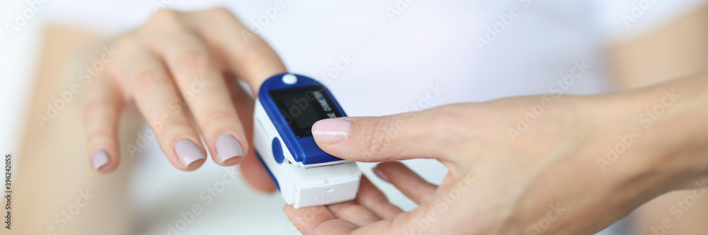 Doctor fixes heart rate monitor on finger Doctor fixes heart rate monitor on finger